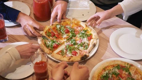 People sharing a pizza. Close up hands Stock Footage 134051432
