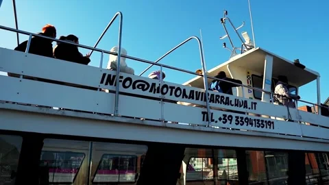 People on a ship prepare to leave the pier near Venice, Italy Stock Footage 262425680