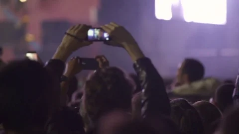 People shoot videos on their cell phones and some of them jumping Stock Footage