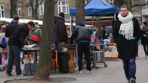 People shop and sell at flea market, pan left, Berlin, Germany Stock Footage