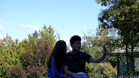 People sightseeing and taking selfie at Queen Elizabeth Park Stock Footage 71481794