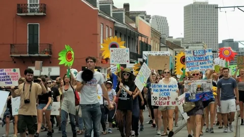 People with signs cheer during climate movement march 2017 New Orleans Louisiana Stock Footage 75657629