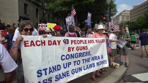 People with signs protesting against firearms in Washington, DC Stock Footage 79533754