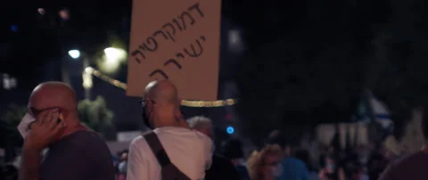 People with signs walking in Jerusalem Stock Footage 152847372