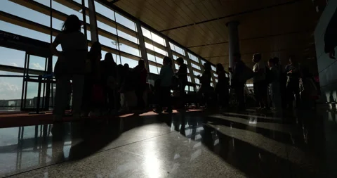 People silhouetted at queue near bording gate at Kunming airport Stock Footage 329627310