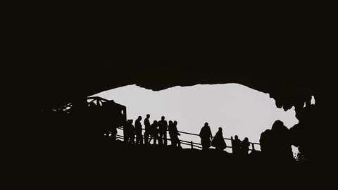 People silhouettes in cave Stock Footage 80340161