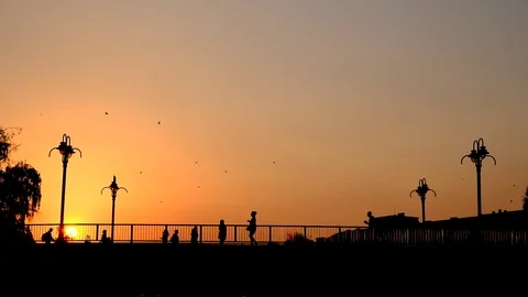People silhouettes crossing the bridge Stock Footage