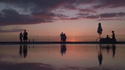 People Silhouettes by Infinity Pool at Sunset in Puerto Naos Stock Footage 343508508