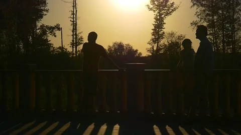 People Silhouettes in Large Sun Disk Family Park Bridge Dad Grandfather Kid Stock Footage 66278827