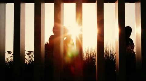 People silhouettes walking at sunset. Handheld shot Stock-Footage 53321371