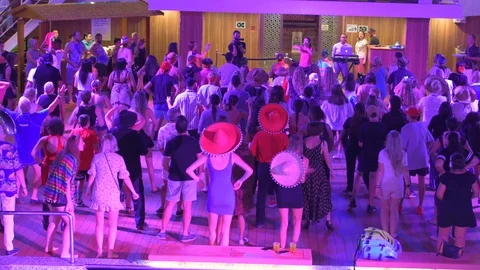 People singing and dancing to YMCA on a cruise ship. Includes audio. Stock Footage 125288686