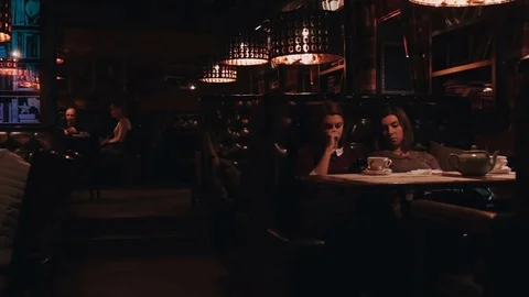 People sit and chat in a cafe Stock Footage 76576723