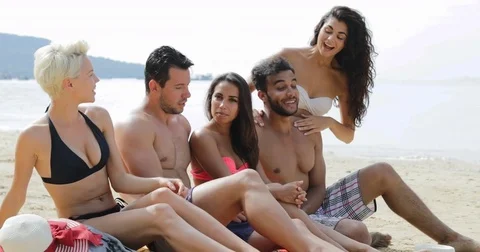People Sit On Beach Talking, Young Happy Man And Woman Group On Vacation Stock Footage 75821317