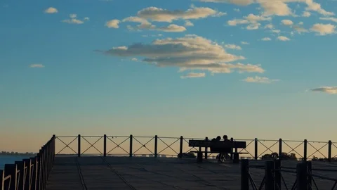 People sit on the bench at the pier Stock Footage 86689493