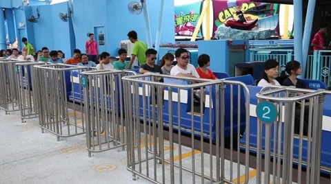 People sit in the booth ride a roller coaster in the Ocean Park Hong Kong Stock Footage 50519052
