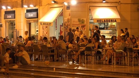 People sit at a cafe on a square at night  in  Valencia city  spain Stock Footage 78532169