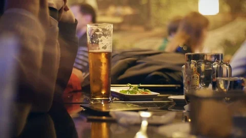 People sit in the evening in the pub and drinking beer. Stock Footage 71673034