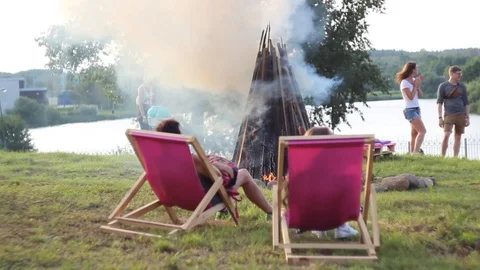 People sit by the fire Stock Footage 92986422