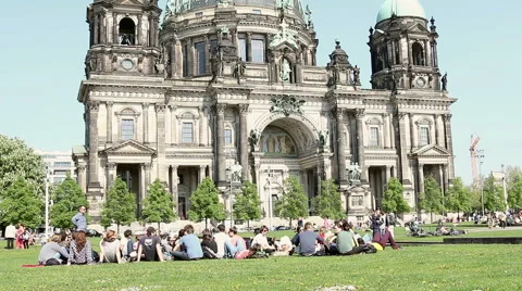 People sit on the grass next to Berlin Cathedral Stock Footage 39986380