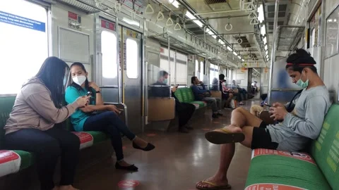 PEOPLE SIT INSIDE COMMUTER TRAIN INDONESIA Video stock 150337874