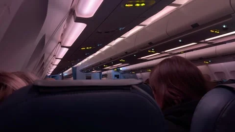 People sit inside a passenger jet just before departure Stock Footage 327363377