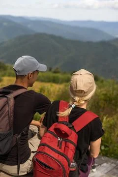 People sit on the ski elevator. View from the back. Summer, green forest. summer 写真素材