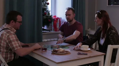 People sit at the table and play cards Stock Footage 58784473