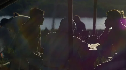 People sit at the table and talk about something Stock Footage 82408584