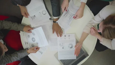 People sit at the table with documents and notebook. Stock Footage 116621569
