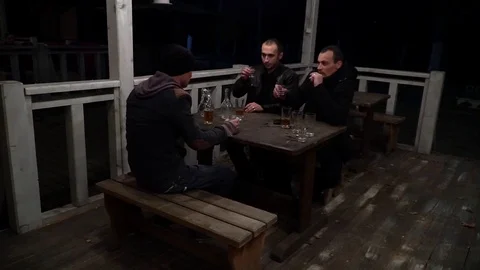 People sit at the table, drink vodka Видео 99275906