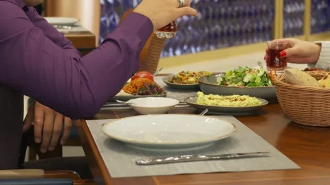 People sit at a table in a restaurant and eat Stock Footage 253631462