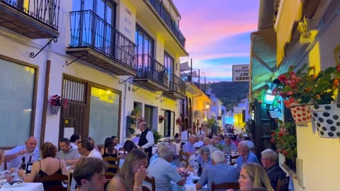 People sitting and having dinner outside in a restaurant with a beautiful Video stock 202459166