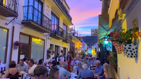 People sitting and having dinner outside in a restaurant with a beautiful Video stock 202897724