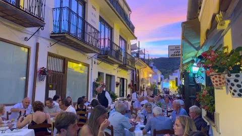 People sitting and having dinner outside in a restaurant with a beautiful Video stock 230412583