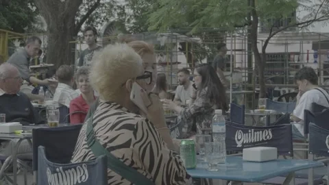 People sitting and having a drink at an outdoor café in Buenos Aires, Argentina Video stock 345138812