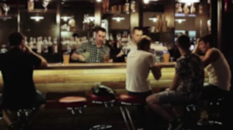 People sitting and relaxing at the bar, bartender clears the bar counter Stock Footage
