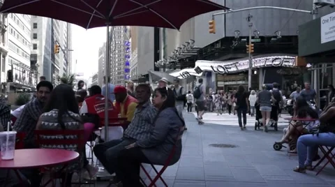 People sitting and walking through busy Time Square Stock Footage 53790071