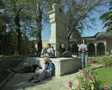 People sitting at base of memorial SD Footage