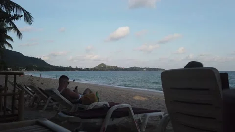 People sitting on the beach during Sunset, La Mai, Samui Stock Footage 220317929