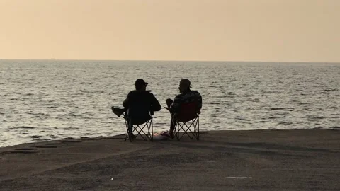 People sitting on the beach Stock Footage 144343901