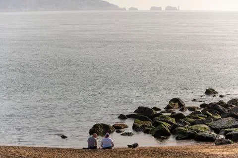People Sitting at Beach Stock Photos