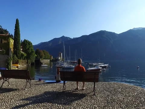 People sitting on a bench in front of the Como lake in Italy. Stock Footage 80496057