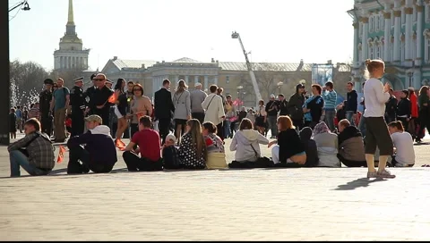 People sitting on the curb. Walking crowd on the background Stock Footage 5653446