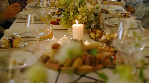 People sitting at the festive table and eating delicious food. 스톡 동영상 288105598
