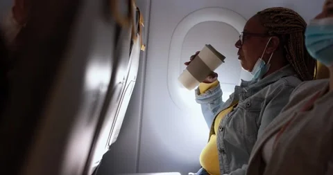 People sitting inside airplane while wearing safety face masks Stock Footage 171864133