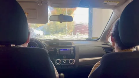 People sitting inside a car going through an automated car wash Stock Footage 348694552