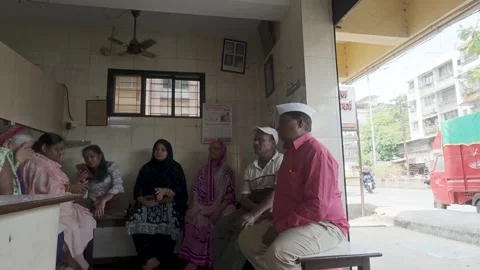 People sitting in a modest waiting room for a medical consultation Stock Footage 335880065