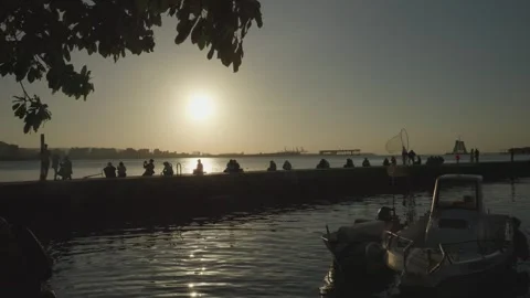 People Sitting on Pier Looking at Sunset in Tamsui District, Taipei, Taiwan Stock Footage 271058880