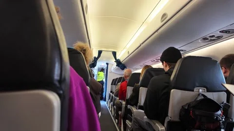 People sitting on a plane and crew preparing for takeoff Video stock 334061865