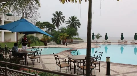 People sitting by the pool on a cloudy day Stock Footage 47887155